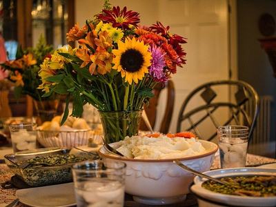 Meal on table with an assortment of flowers in the middle.