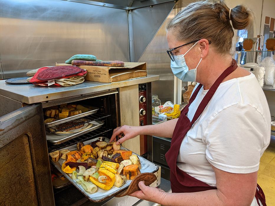 Sarah Sligh checks on the roasting veggies