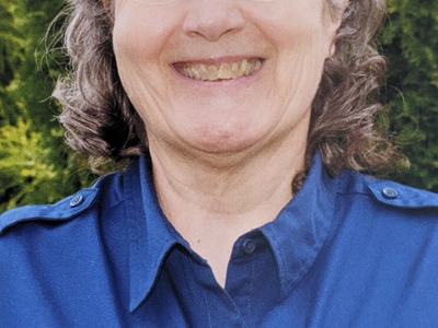 Person wearing blue shirt with "NC Cooperative Extension Henderson County" logo