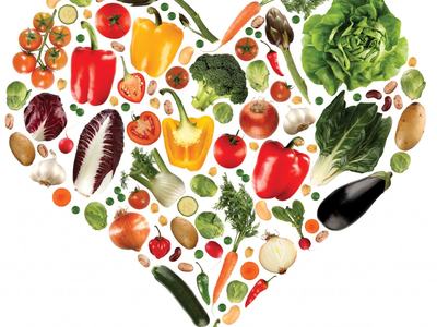Vegetables and fruits arranged in the shape of a heart.