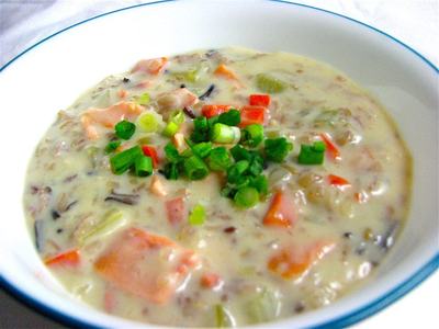 Bowl of creamy chowder with diced vegetables and chopped green onions