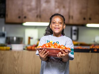4-Her holding a bowl of tomatoes