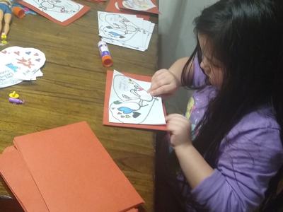 Ava T. works on cards.