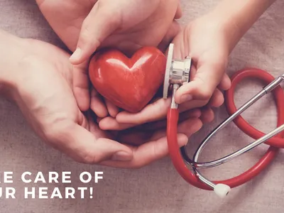 red heart in hands with stethoscope
