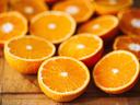 oranges cut into halves on a wooden table