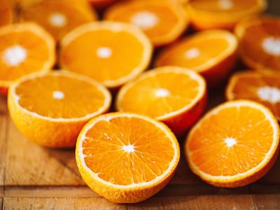 oranges cut into halves on a wooden table
