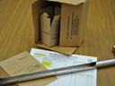 Close-up of a soil testing box and soil probe resting on a table, used for collecting soil samples for analysis.