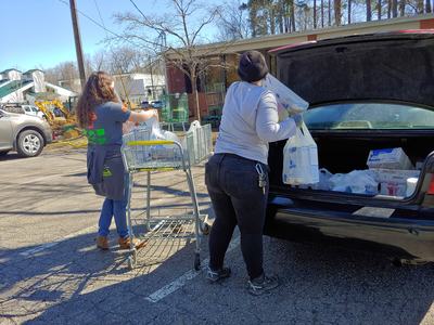 People getting food out of trunk of car