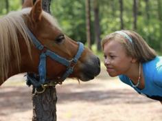 Girl kissing horse