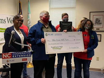 2021 Small Farmer of the Year check awarded by NCA&T to Mike Jones and family