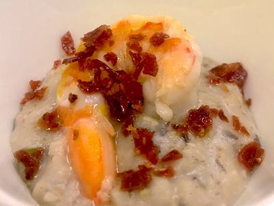 Cooked shrimp on creamy risotto topped with crumbled bacon