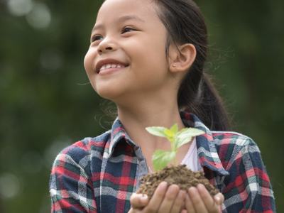 girl holding seedling