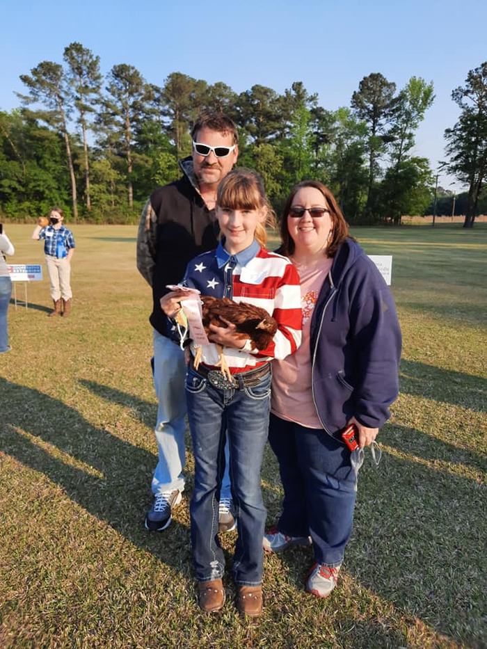 Girl holding a chicken