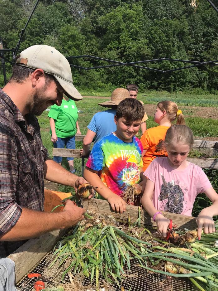 Children and man gardening