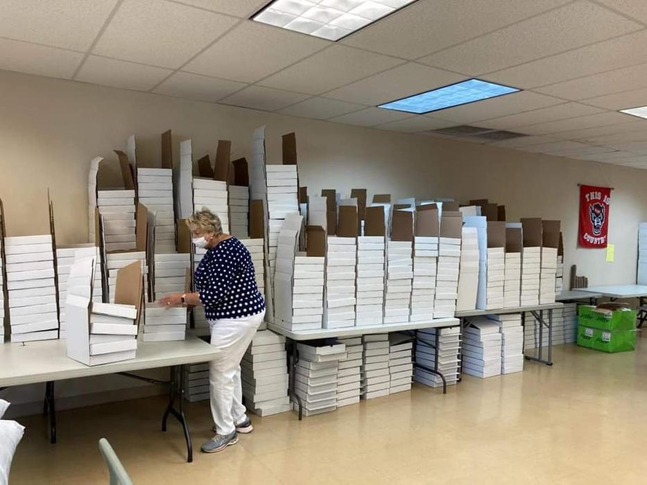 volunteer organizing the seed kit boxes
