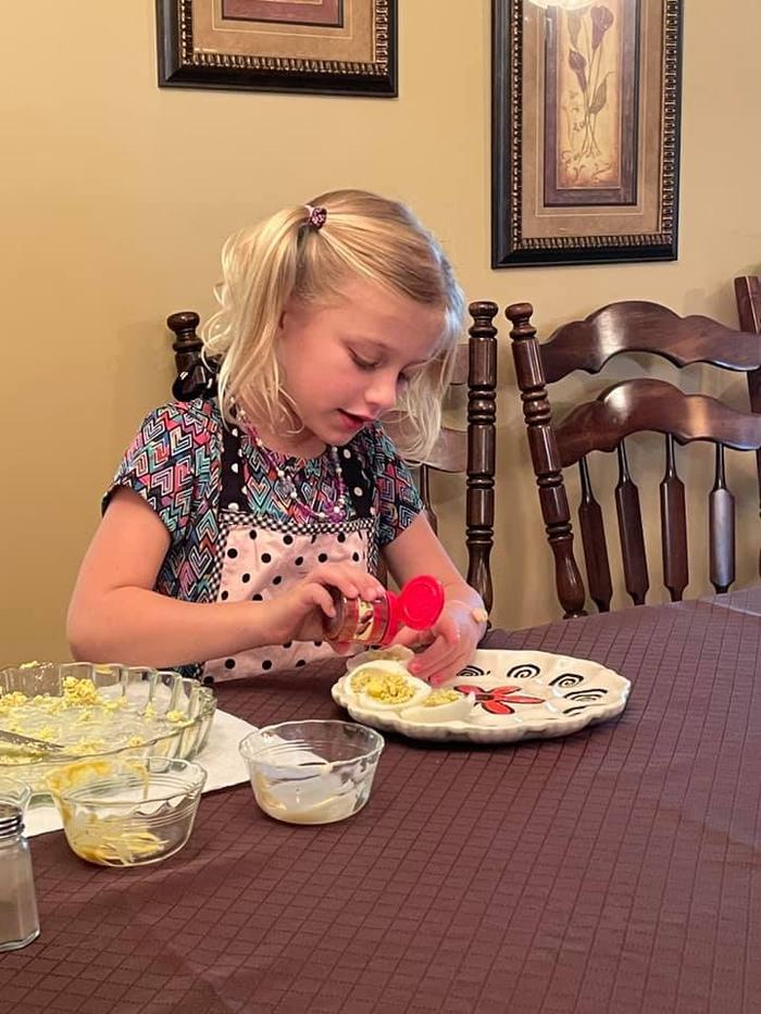 Girl making deviled eggs