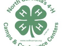 Green four-leaf 4‑H clover logo with text: "North Carolina's 4-H Camps & Conference Centers"