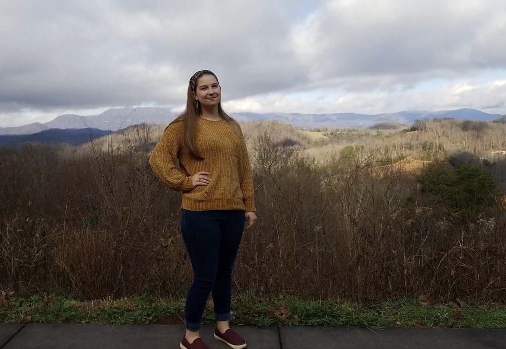 Woman standing in front of mountains in the background