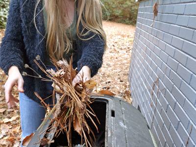 Woman using compost bin