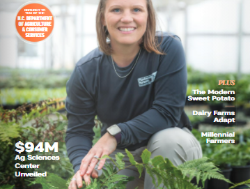 North Carolina Agriculture cover: woman kneeling among potted ferns in greenhouse; "Going Green"