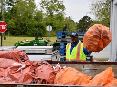 man with garbage bag during Clean Sweep