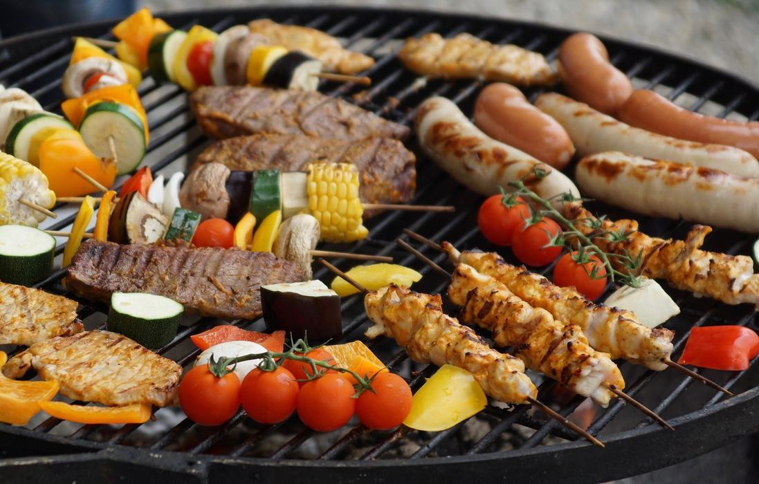 kebabs and vegetables on skewers on grill