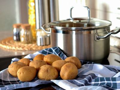 kitchen background, stock pot, potatoes and a dishcloth