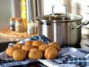 kitchen background, stock pot, potatoes and a dishcloth