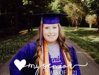 Girl with graduation gown looking at camera