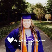 Girl with graduation gown looking at camera