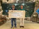 Two men holding big check