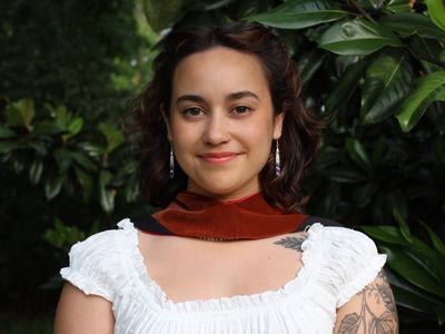 Woman standing in front of trees