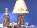 Two mason jar lamps and three lamp sockets with cords on blue background
