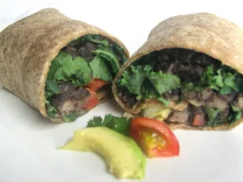 Whole-wheat wrap halves filled with black beans, lettuce, avocado and tomato
