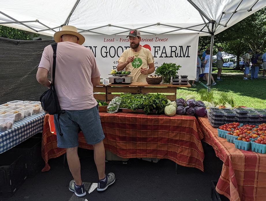 People at farmers market booth
