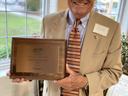 Man holding plaque