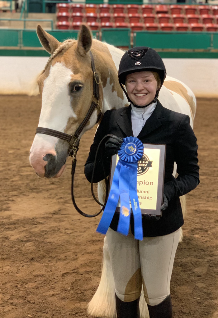 Girl with horse holding award