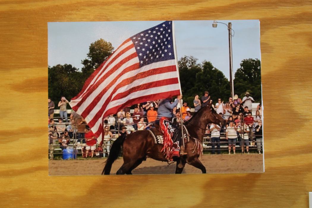 Photo of a man on horse carrying a flag