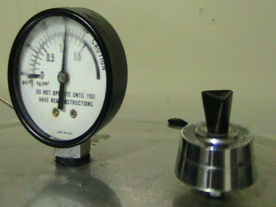 Pressure gauge on metal lid at zero; text "DO NOT OPERATE UNTIL YOU HAVE READ INSTRUCTIONS"