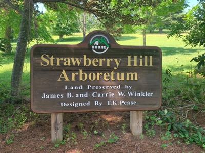 Wooden sign with Strawberry Hill Arboretum printed