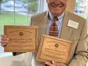 Man holding plaques
