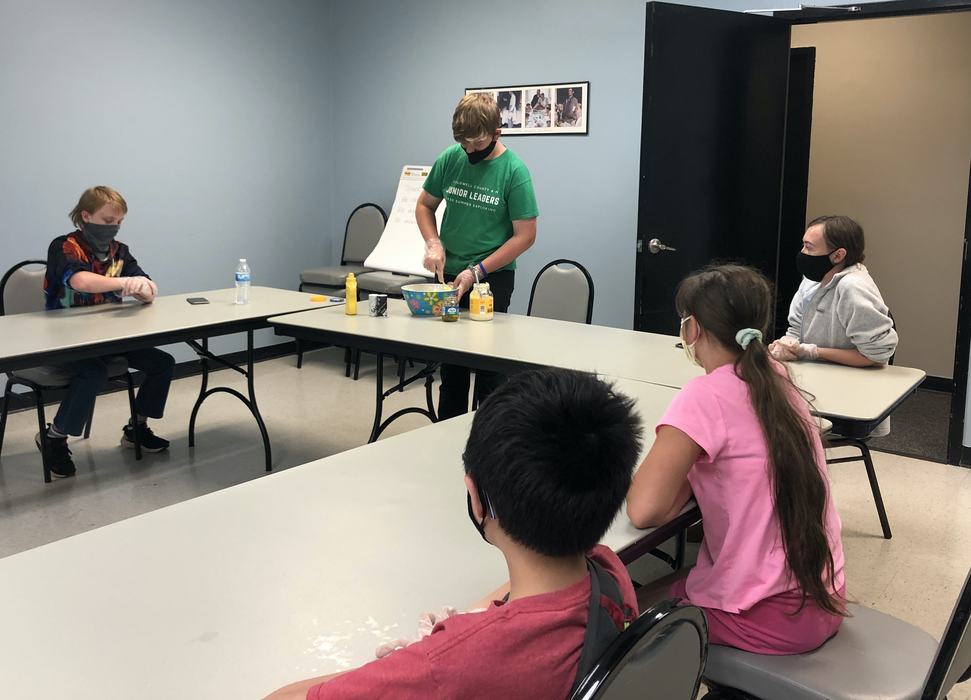 Junior leader Peyton Denning demonstrates how to prepare egg salad during a 4-H program in July 2021. 