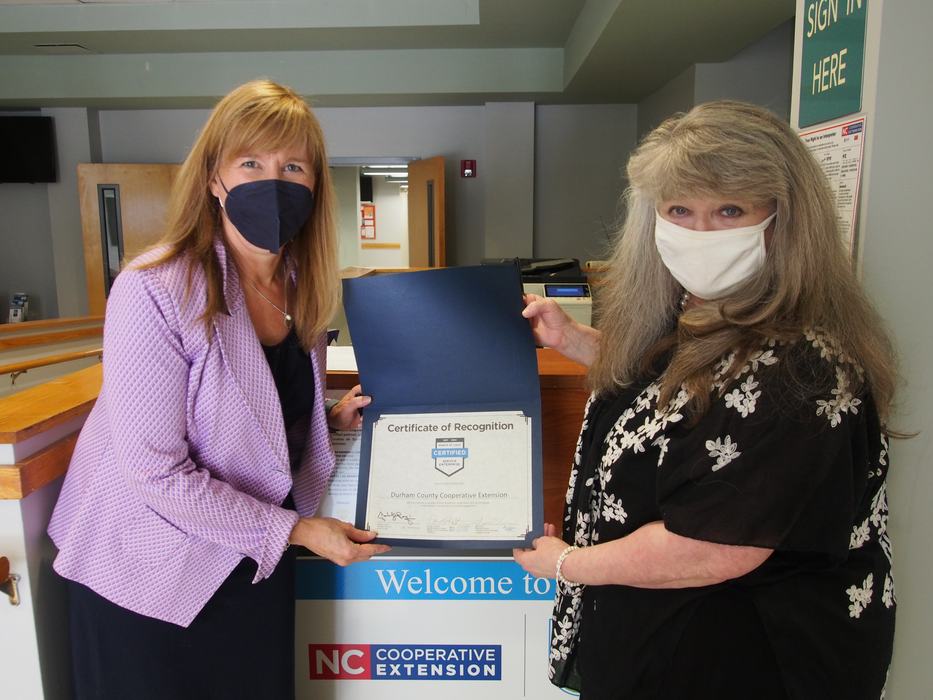Two women holding a certificate