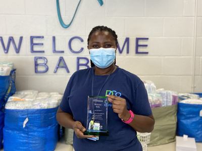 Patience Mukelabai displaying The "Making A Difference" Award from Alliance Health Plan