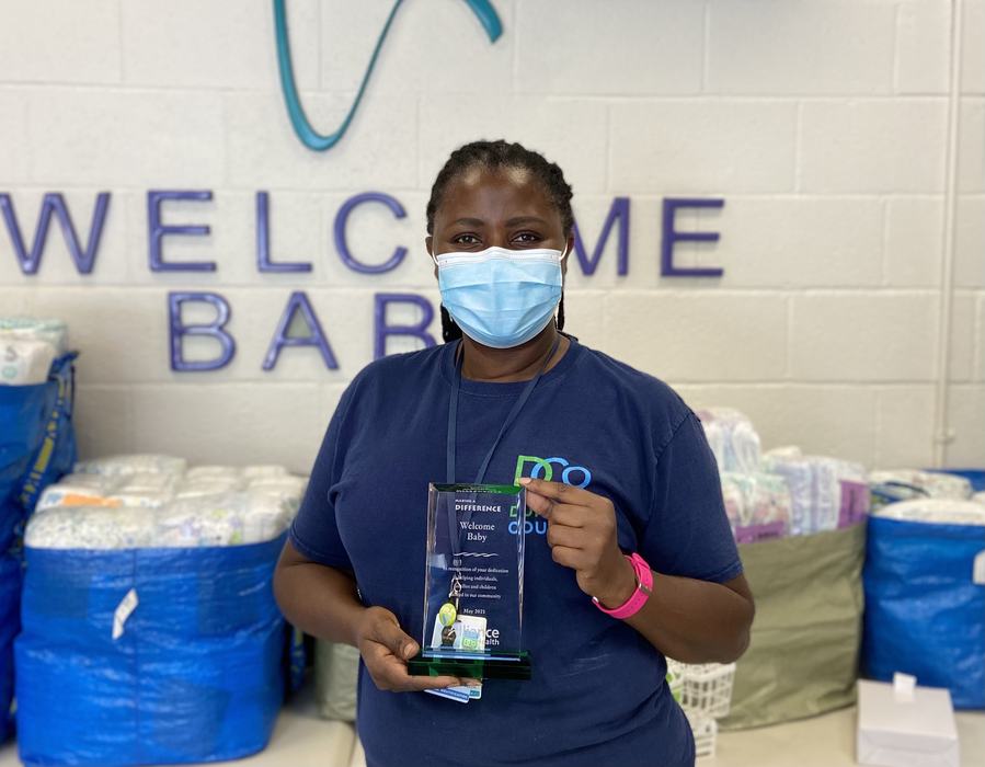 Patience Mukelabai displaying The "Making A Difference" Award from Alliance Health Plan