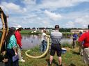 Man with hose and people watching