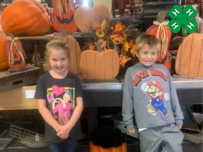 two kids with pumpkins