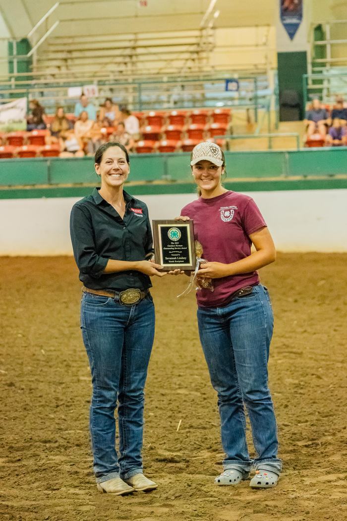 Two women holding a plaque