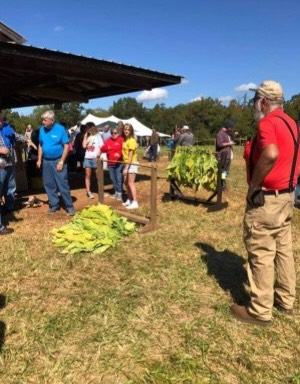 Man speaking to crowd on farm