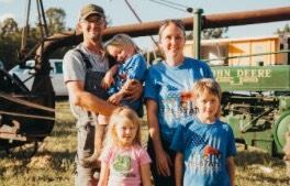 Man, woman, and three children looking at camera